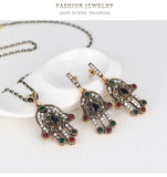 Turkish Style Hand of Fatima necklace and earrings set with red colored  stones